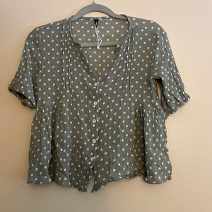 Nerlerolian cropped top in a light sage green with white dots.
